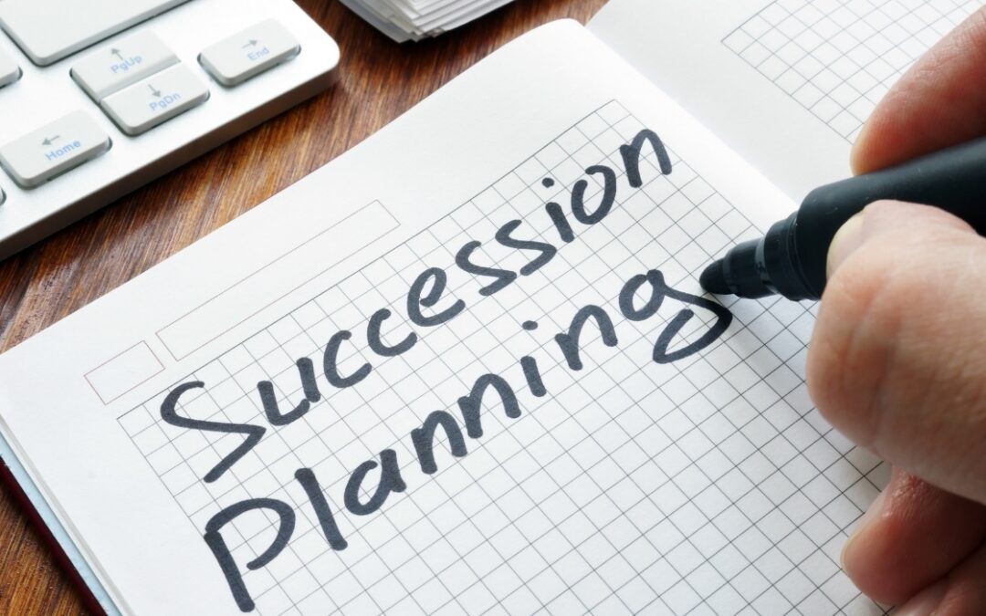 Business Succession Planning written on a sheet of graph paper