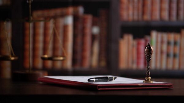 a pen rests on an estate plan next to a wax seal