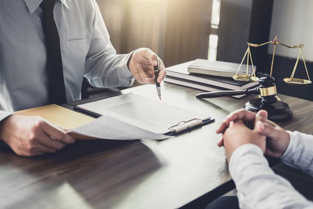 An estate attorney discusses a trust with a client